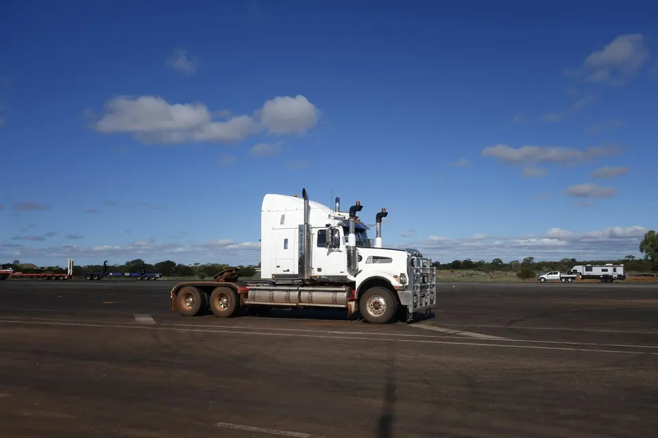 White semi truck parked on asphalt