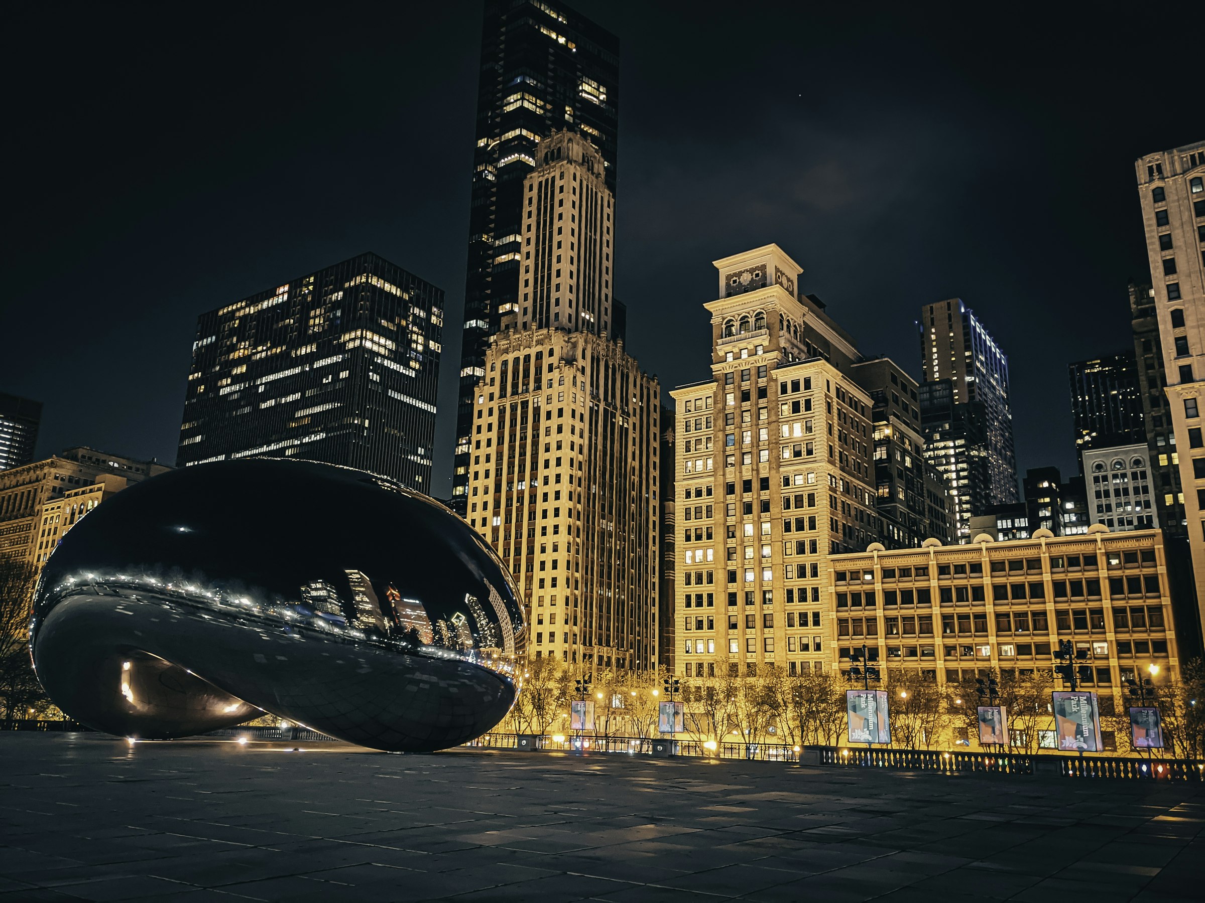 Chicago skyline illuminated beside the river at night